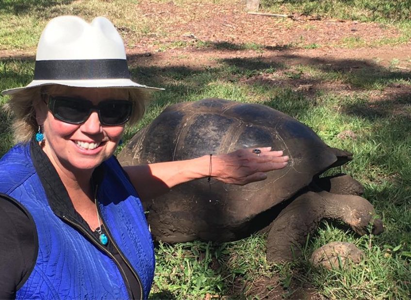 Carol with Galápagos land tortoise (world's largest) reaching over 4.2ft and 660 lbs.
