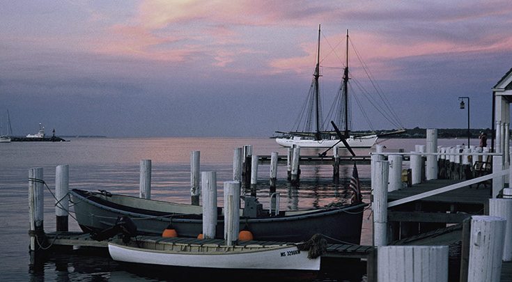 Martha's Vineyard harbor at sunset docks and boat