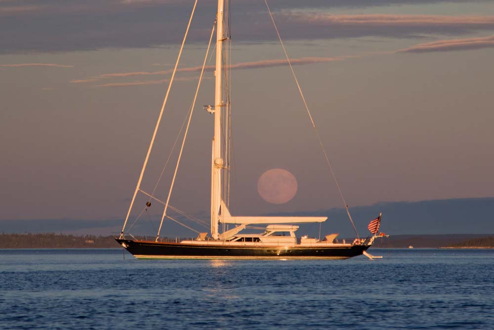 S/Y Marae with huge full moon rising over the ocean. Photo by Frank Ficken©2017