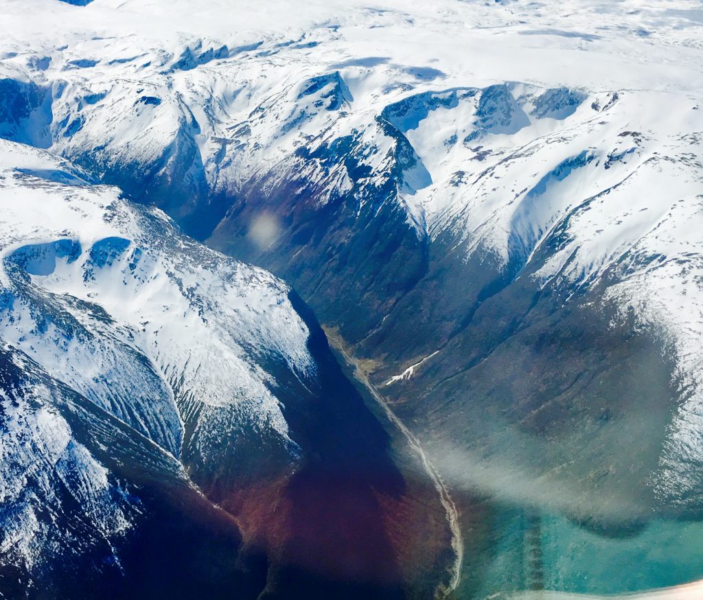 River valley with snow-capped mountains in Norway