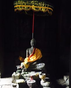 Orange shawl across Buddha sculpture at Angkor Wat, Cambodia