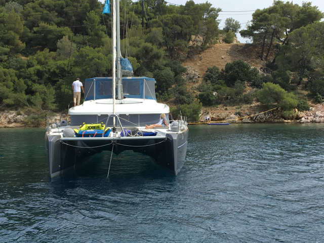 Catamaran anchored in quiet Greek cove
