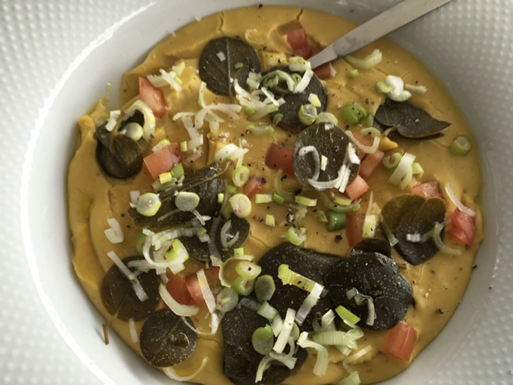 Soup garnished w scallion tomatoes on our sailing the Peloponeese in Greece FAM Trip