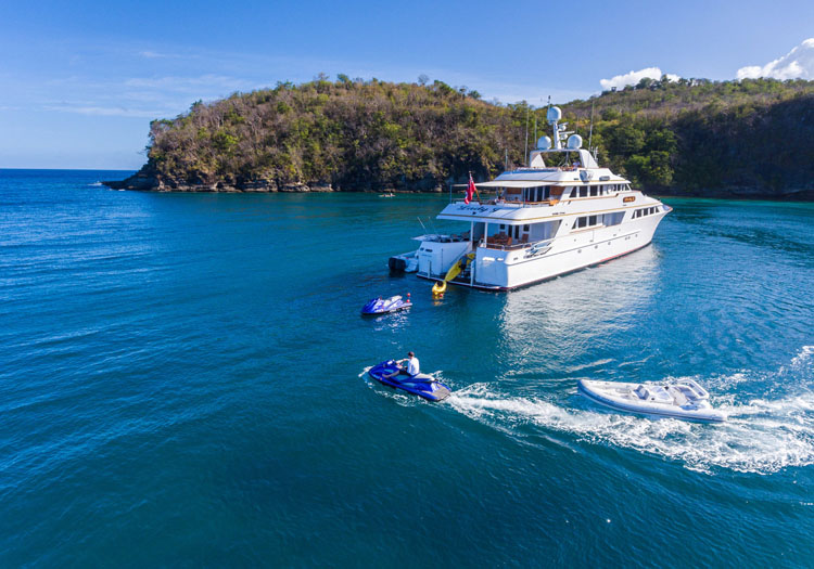 Tenders and SkiDoos motor around 142ft M/Y LADY J in the Caribbean