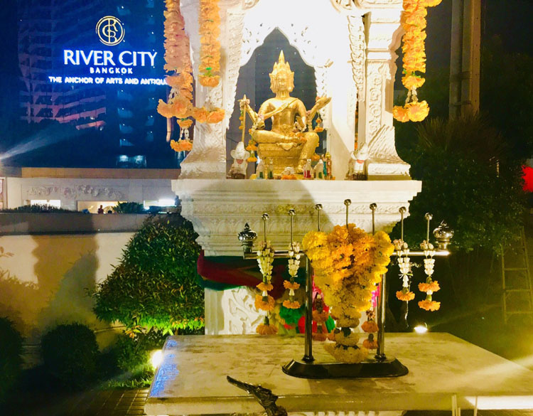 Buddha and decorated altar in Bangkok, Thailand's River City.
