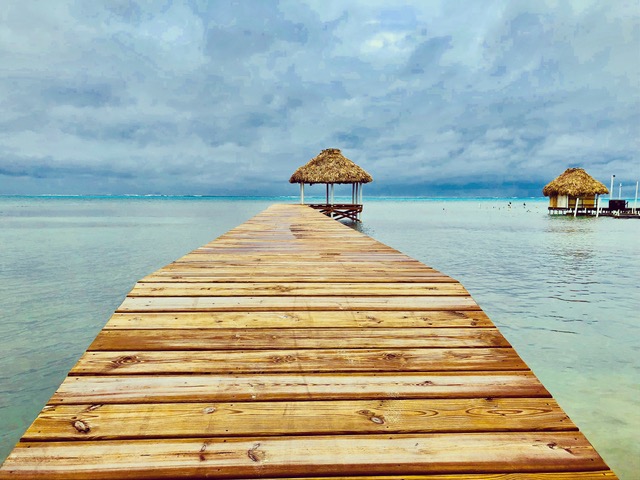 Dock leading out to pavilions in Belize's blue water