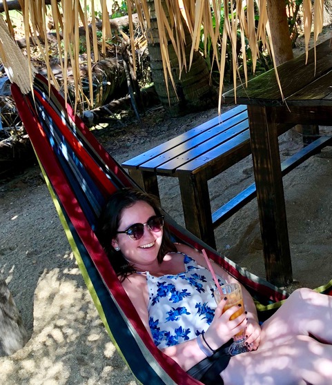 Molly Gearan swinging in a colorful hammock in Belize