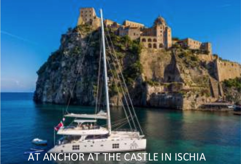 70ft sailing catamaran OMBRE BLU 3 at anchor at castle on Ischia, Amalfi Coast, Italy