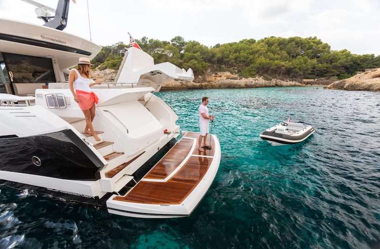 Passengers on aft deck of 74ft Sunseeker motor yacht STRATEGIC DREAMS at sea