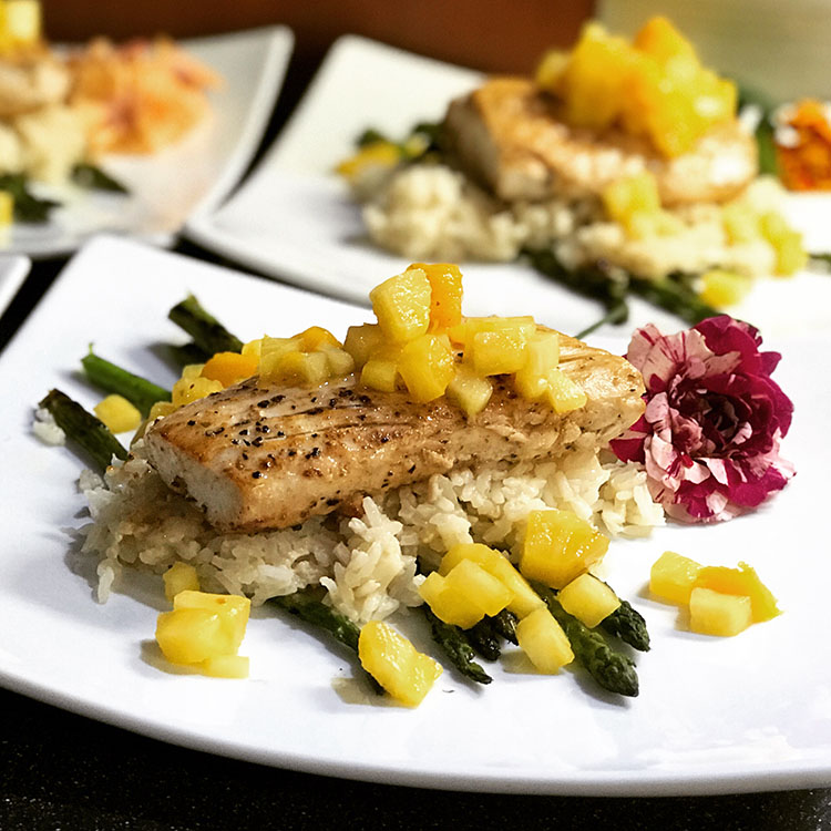 Sautéed Mahi over a bed of Coconut Rice served over Blistered Asparagus with edible flowers S-Y STARFISH