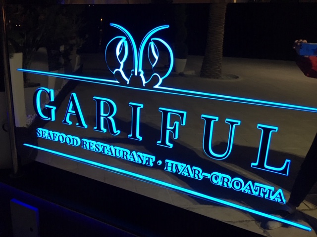 Gariful restaurant table and chairs on glass floor above fish tank