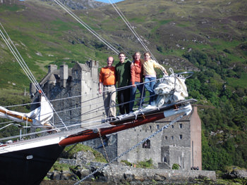 Passengers on the 72ft schooner BONNIE LYNN in Scotland passing a castle