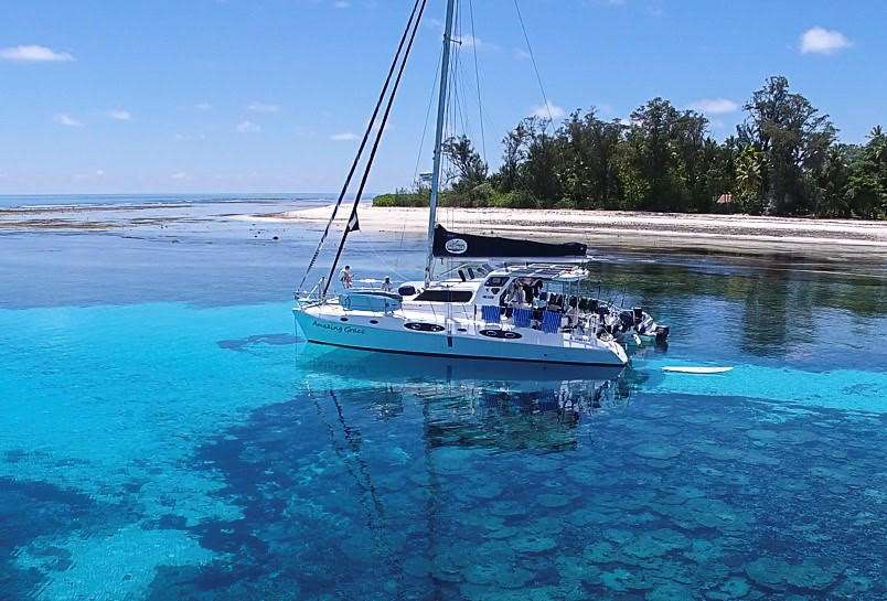 53ft Royal Cape S-Y Catamaran AMAZING GRACE moored near a white sand island