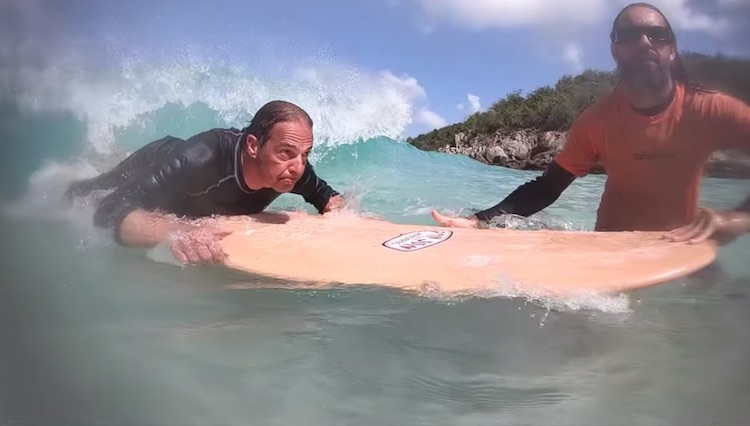 LOLALITA guest on surfboard with surfing instructor in British Virgin Islands