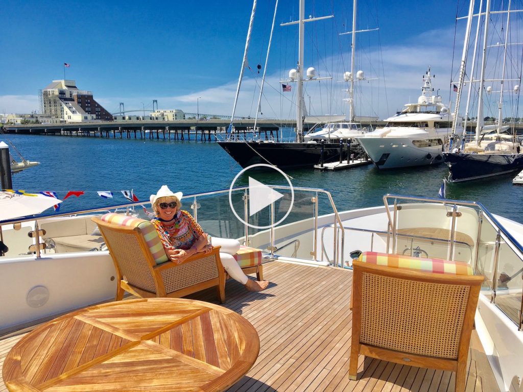 Carol Kent, President of Carol Kent Yacht Charters International, in a comfy chair on board a yacht deck in Newport, Rhode Island where she is vetting boats. Link to YouTube Channel