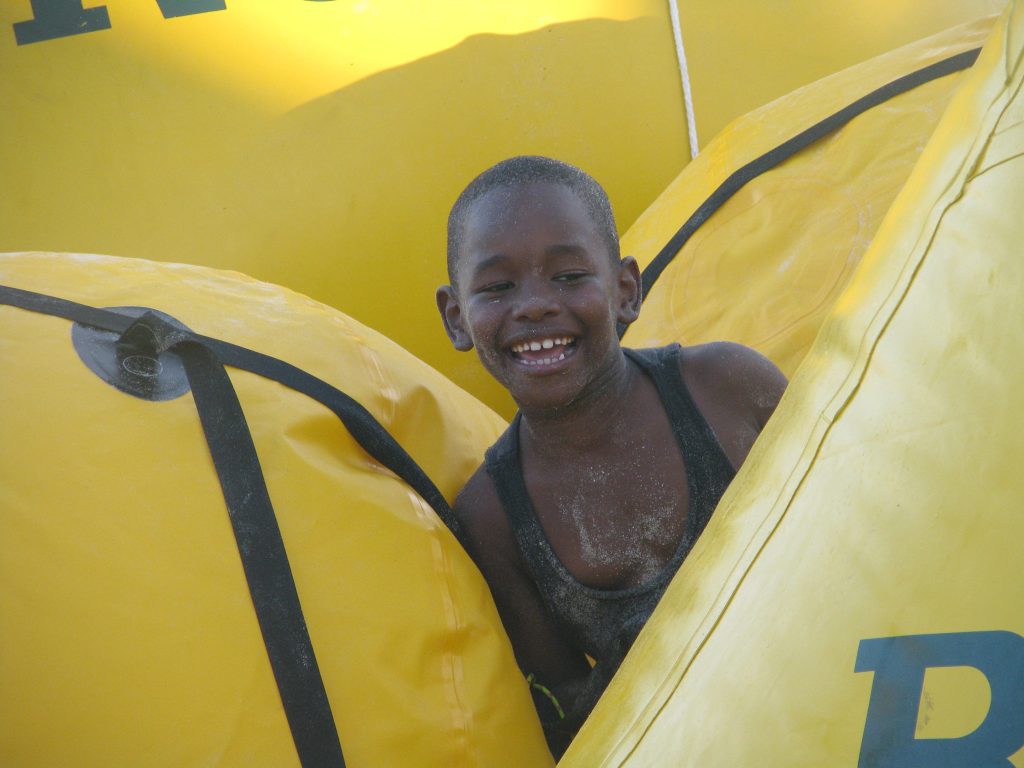 Boy in yellow liferafts at regatta time in St. Thomas US Virgin Islands (USVI)